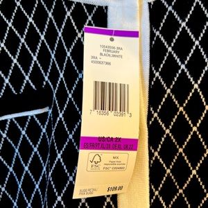 Black and white piece with silver buttons. Never worn!